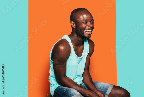 Happy young black man laughing away with summer outfit photo