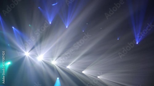 Blue Stage Ray Of Light In Concert Hall. Lighting lamp rays shiny dynamic effect. Laser lights on the stage.  Professional lighting and show effects.