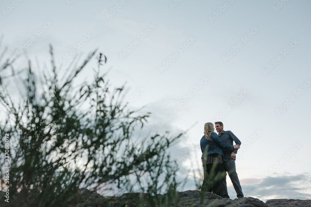 Middle age couple together outside at sunset Middle age couple together outside at sunset