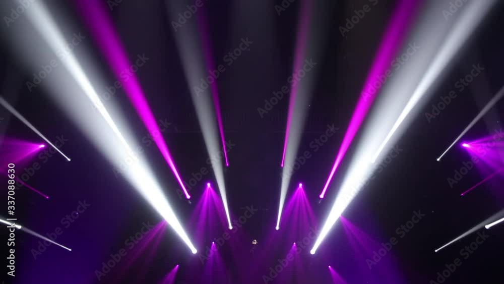 Stage Ray Of Light In Concert Hall. Lighting lamp rays shiny dynamic effect. Laser lights on the stage. Professional lighting and show effects.Professional lighting and show effects.