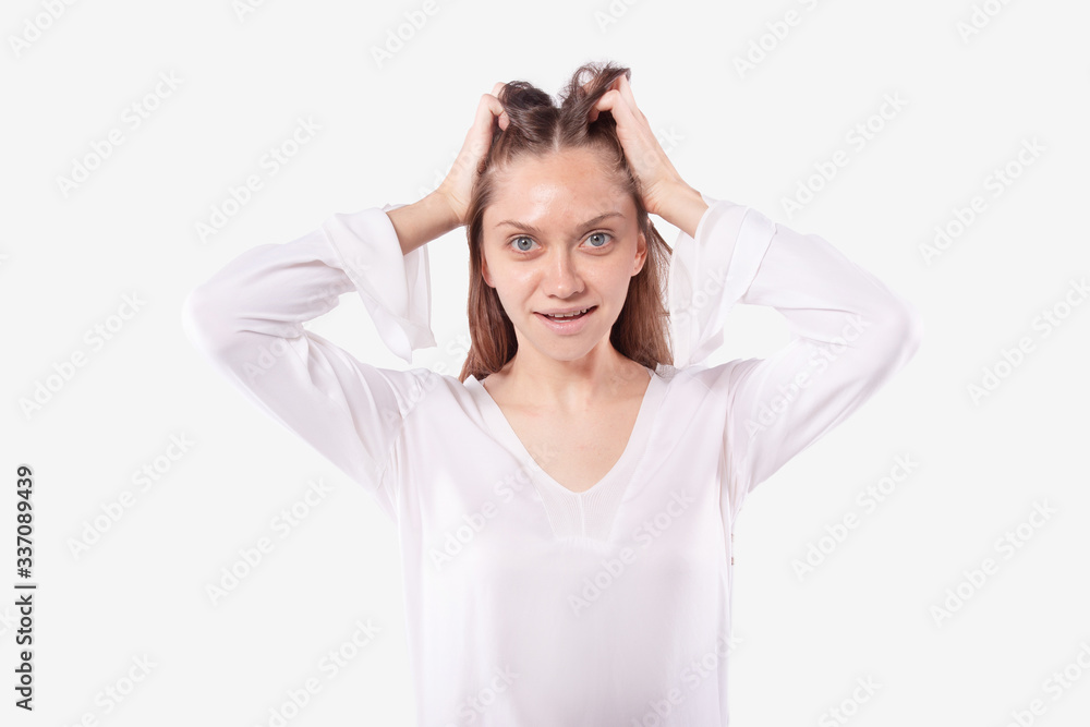 Young girl no makeup smiles joyfully, hands in hair. Pleasantly surprised Young girl no makeup smiles joyfully, hands in hair. Pleasantly surprised