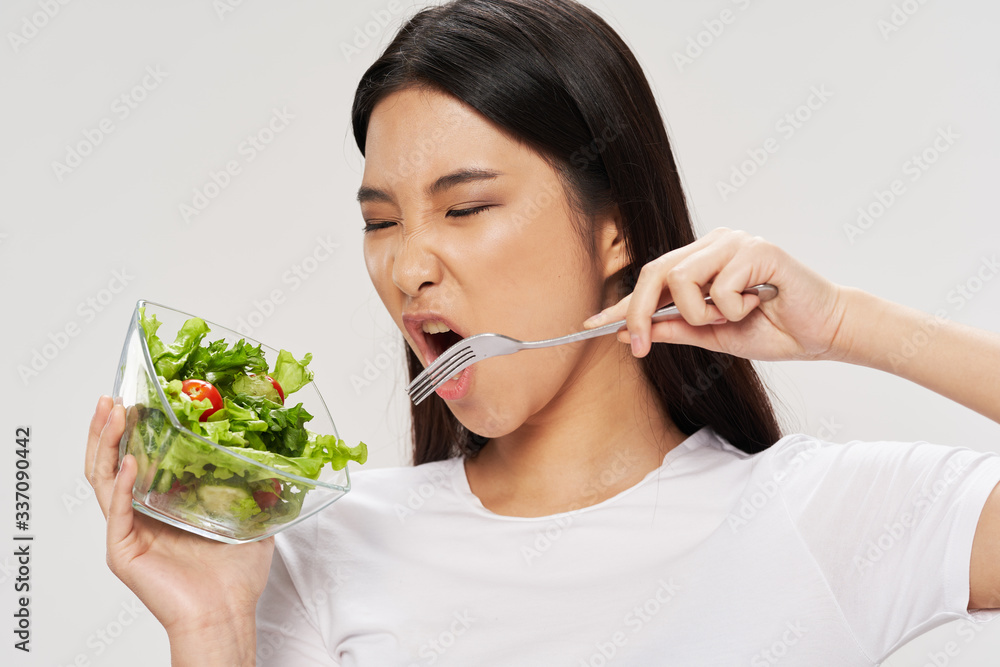 young woman eating salad