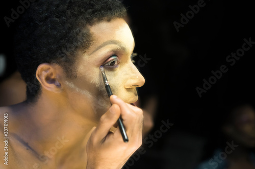 Close-up of Drag Queen Applying Eye Make-up photo