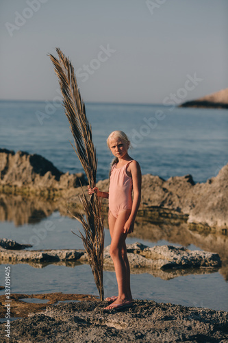 Little girl on the rocky coast