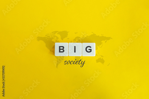 Big society concept. Block letters, cursive font and world map on yellow background. photo