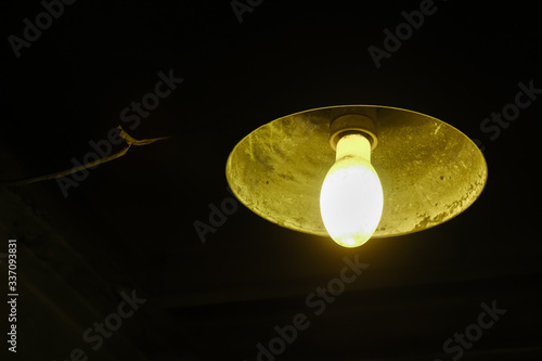 Old dirty lantern, the electric lamp dimly shines.