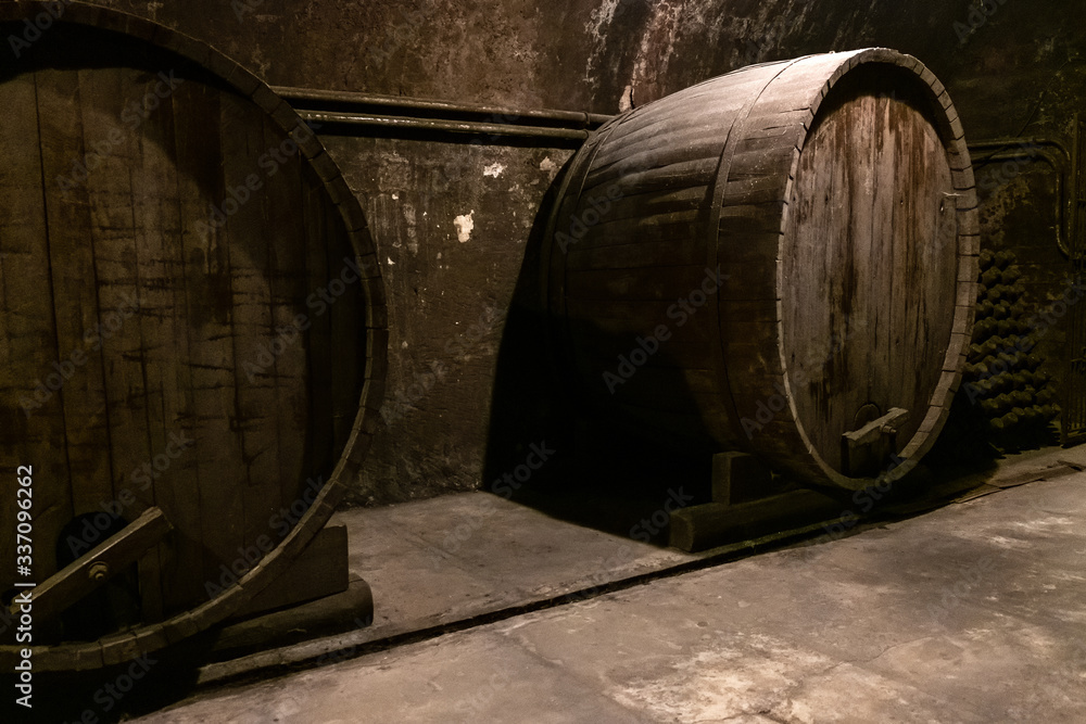 Dark old cellar with large wine oak barrels Dark old cellar with large wine oak barrels