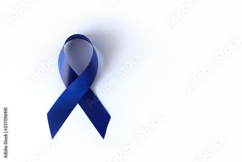 Blue ribbon on a white background is a symbol of the problem of Stevens-Jones syndrome, colon cancer, problem of hydranencephaly, chronic fatigue syndrome, myalgic encephalomyelitis. Week no smoking photo