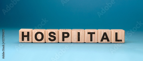 HOSPITAL word cube on a blue background. Medical concept.