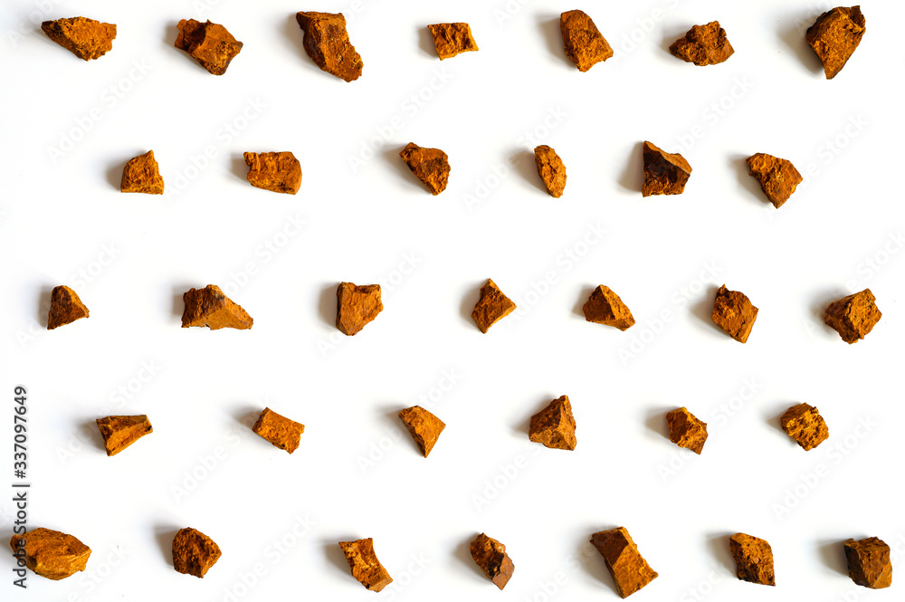 chaga mushroom. broken pieces of birch tree chaga mushroom for brewing natural medicinal antitumor, anti-inflammatory and antiviral detox tea, isolation on white background. regular pattern chaga mushroom. broken pieces of birch tree chaga mushroom for brewing natural medicinal antitumor, anti-inflammatory and antiviral detox tea, isolation on white background. regular pattern