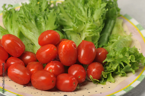 cherry tomatoes with lettuce leaves on a plate