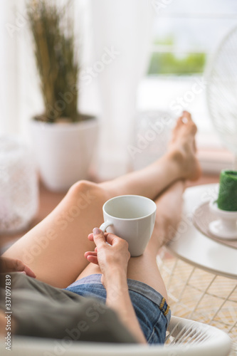 young girl resting and drinking coffee at home