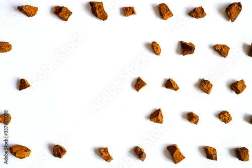 chaga mushroom. broken pieces of birch tree chaga mushroom for brewing natural medicinal antitumor and antiviral detox tea, isolation on white background. regular pattern. space for text