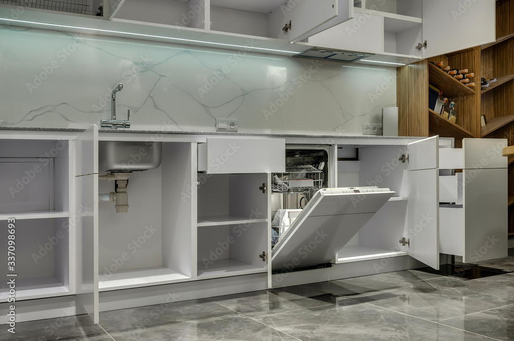 Multifunctional modern kitchen. Opened cabinets and drawers Multifunctional modern kitchen. Opened cabinets and drawers