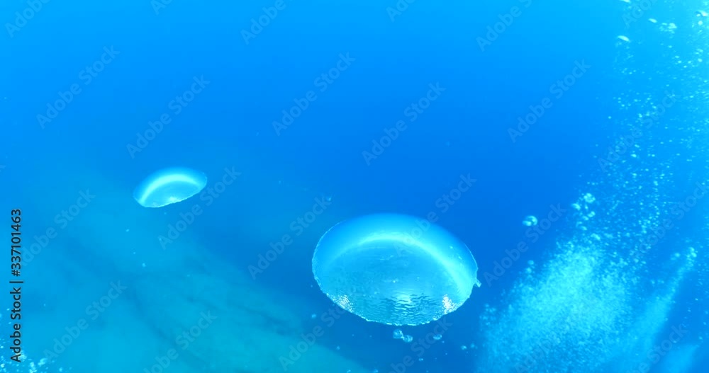 air bubbles coming up to the surface from scuba divers with sun beams and rays air bubbles coming up to the surface from scuba divers with sun beams and rays