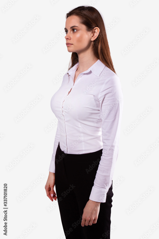 Caucasian girl stands half-sides and looks straight ahead. White background Caucasian girl stands half-sides and looks straight ahead. White background