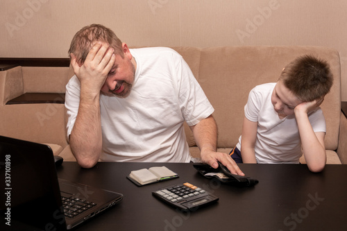 Father and son are considering spending in the family budget. Money problems during the crisis.