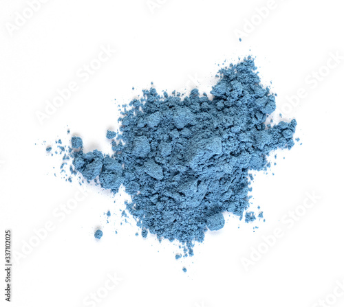 Close-up of blue matcha tea powder isolated on a white background