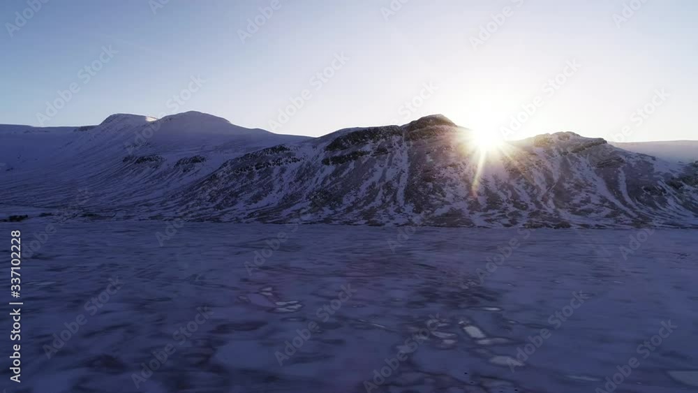 Snowy mountain sunset in Iceland, wide aerial Snowy mountain sunset in Iceland, wide aerial
