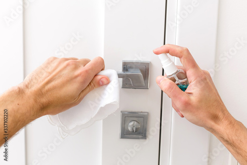 men use alcohol paper to hold Door knob to prevent infection and the covid 19 virus outbreak. Prevent Covid from touching the door.