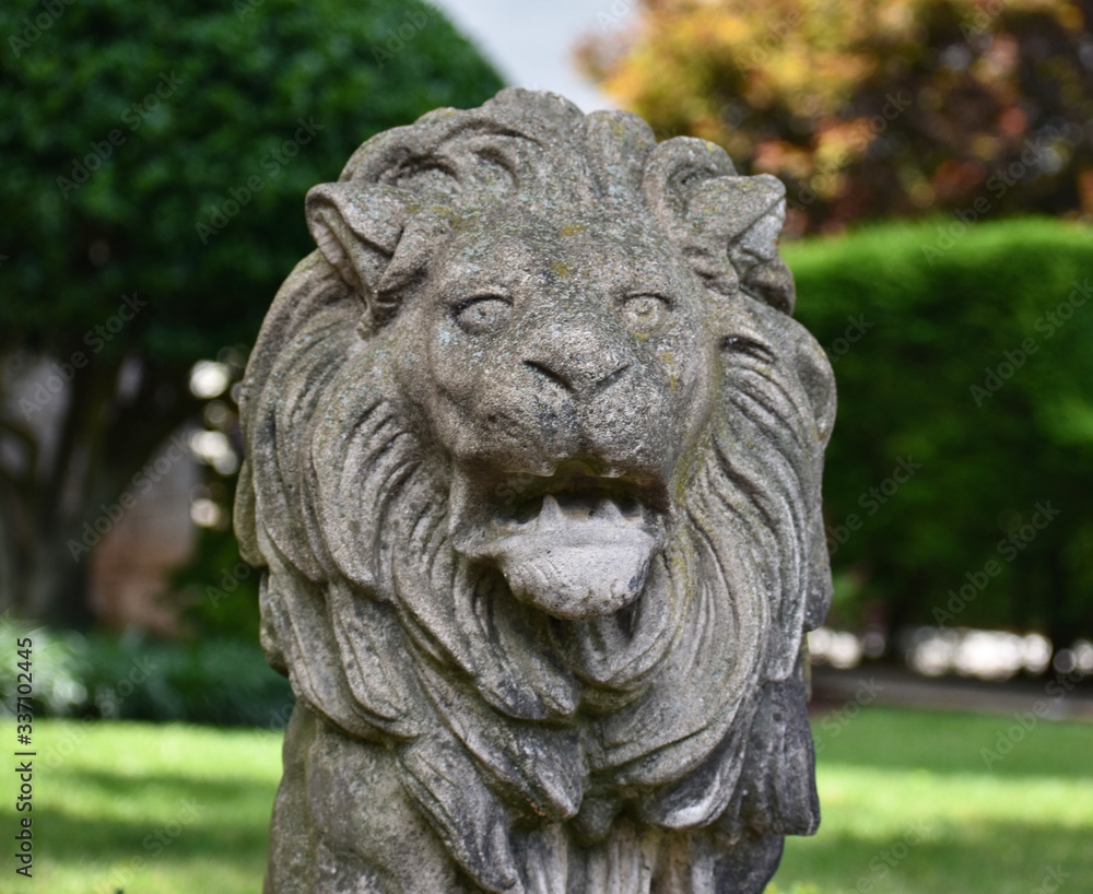 Front yard landscape featuring a lion statue