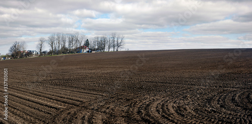Landscape of spring arable field of agricultural field while preparing land f...