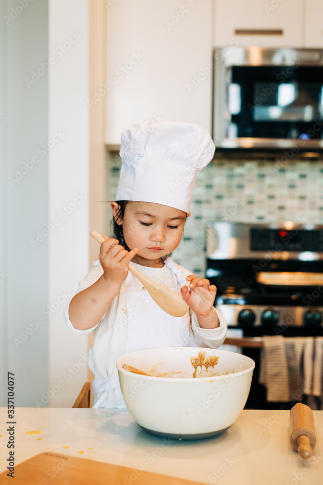 Toddler Girl Baking Cookies Wearing Toque Toddler Girl Baking Cookies Wearing Toque