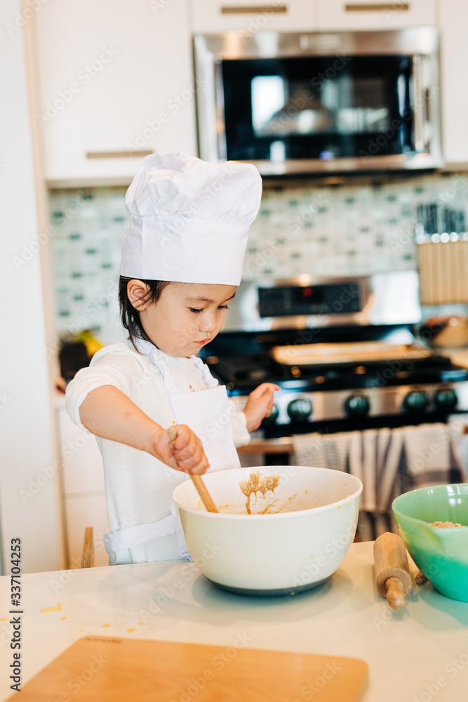 Toddler Girl Baking Cookies Wearing Toque Toddler Girl Baking Cookies Wearing Toque