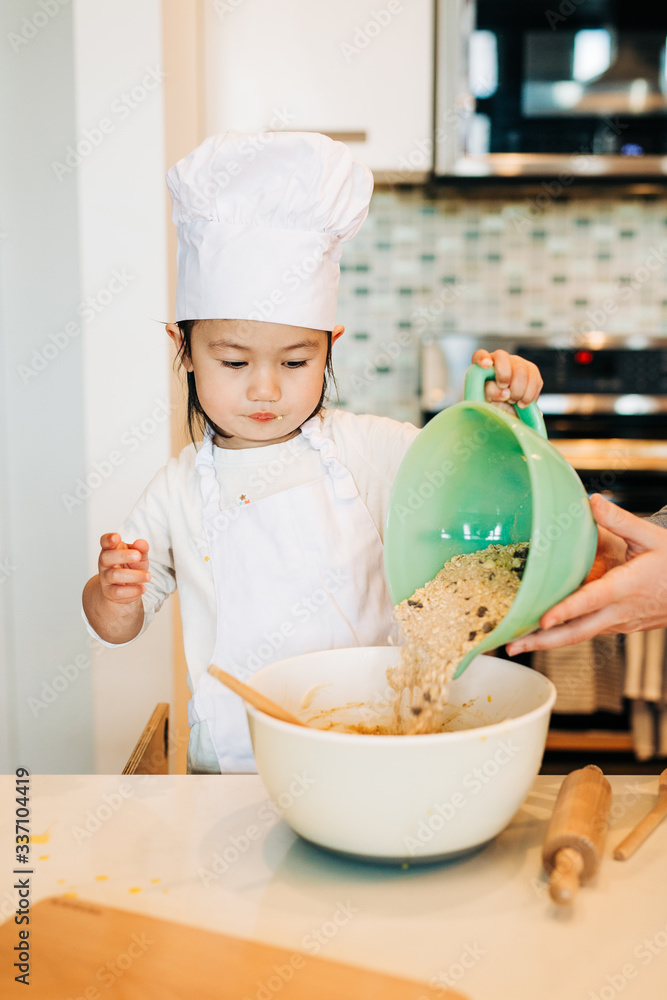 Toddler Girl Baking Cookies Wearing Toque Toddler Girl Baking Cookies Wearing Toque