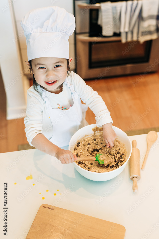 Toddler Girl Baking Cookies Wearing Toque Toddler Girl Baking Cookies Wearing Toque
