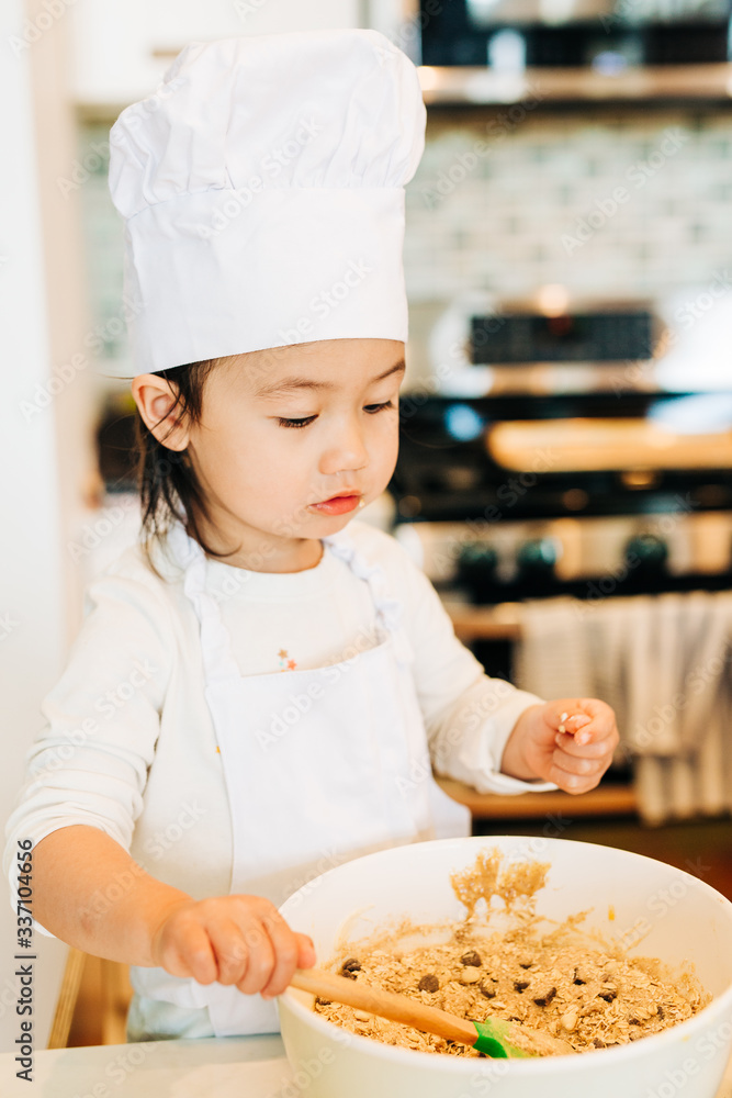 Toddler Girl Baking Cookies Wearing Toque Toddler Girl Baking Cookies Wearing Toque