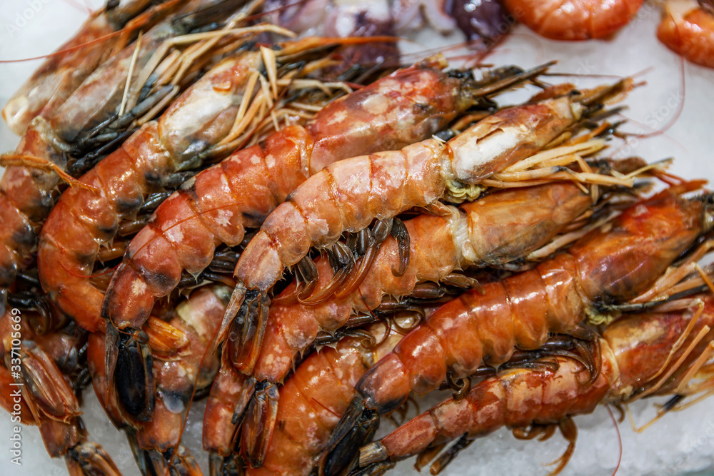 Appetizing large shrimp on a store counter. Close-up. Appetizing large shrimp on a store counter. Close-up.