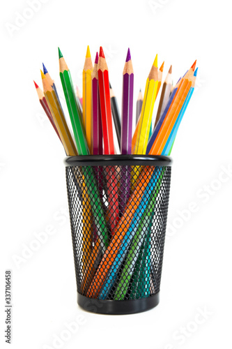 Bunch of colored pencils in a pencil holder. Macro still-file picture made in studio with white background and softbox.