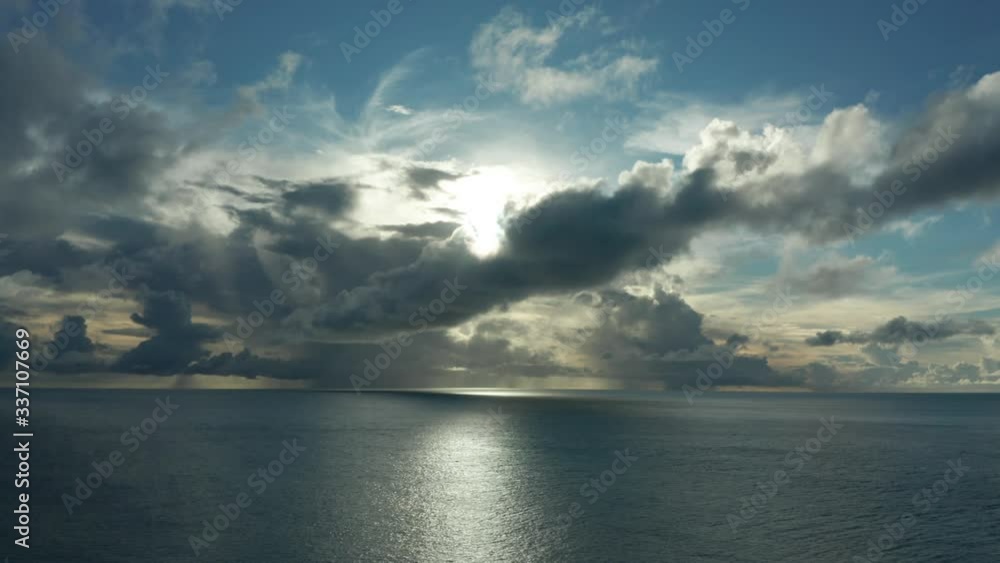 Stunning Scenery Of The Bright Sun Behind The Dramatic Clouds Above The Deep Blue Ocean In An Island In Fiji - Wide Shot Stunning Scenery Of The Bright Sun Behind The Dramatic Clouds Above The Deep Blue Ocean In An Island In Fiji - Wide Shot