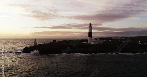 Colorful sunset over Portland Bill Lighthouse, wide aerial