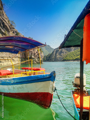 A boat with a canopy on the river. River boat. Pleasure boat on the river in Albania. photo