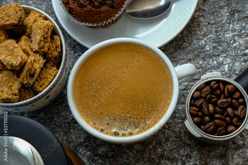 Coffee cup on wooden rustic background. Top view with morning sunlight