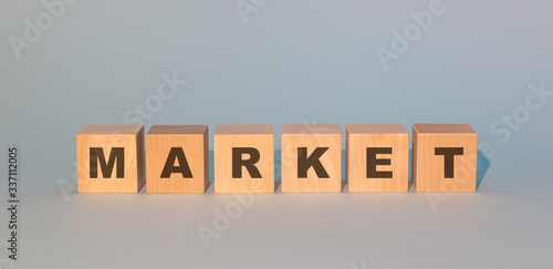 wooden cubes with the inscription of the market on a gray background