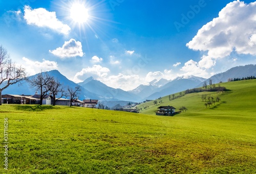 View on bavarian and brandengerg alps, green fields with blue sky at sunset. Tyrol, Austria, nearby Thiersee, Hinterthiersee, Kufstein. Border with Bavaria, Germany, Bayrischzell, Wendelstein.