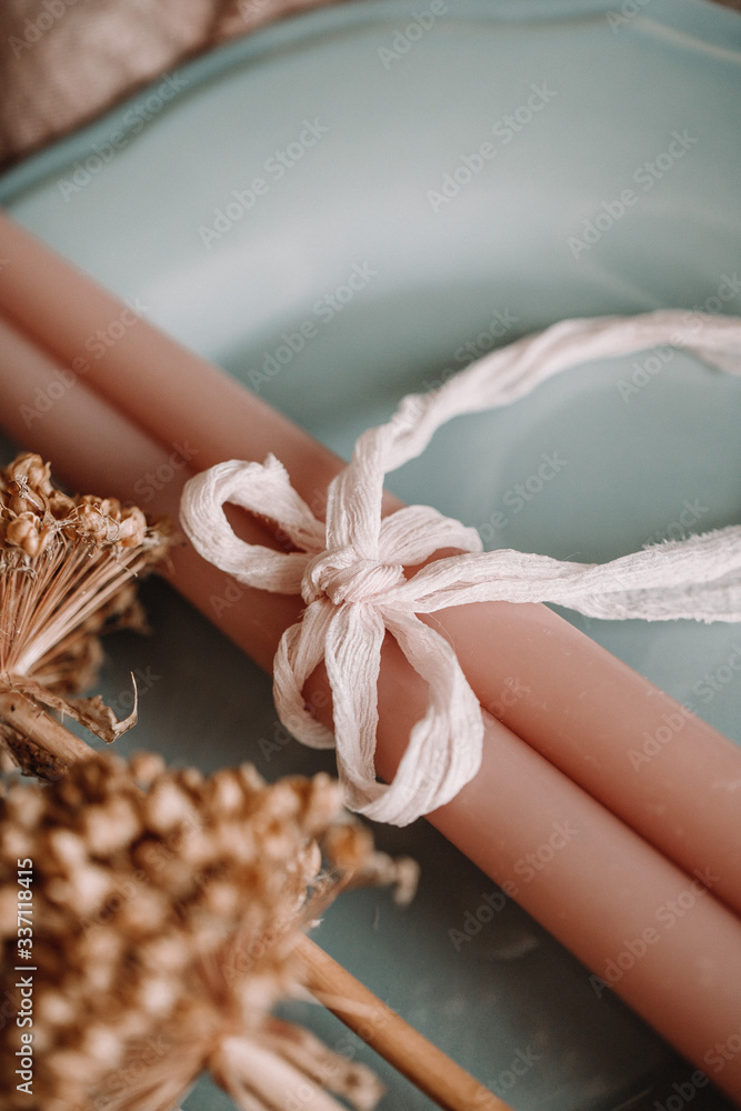 Focus view of cute and elegant cloth fabric use to tie candle. Wedding decoration on the plate. Fancy golden flower on the side perfect for props photography. Focus view of cute and elegant cloth fabric use to tie candle. Wedding decoration on the plate. Fancy golden flower on the side perfect for props photography.