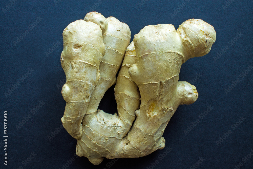 Fresh ginger root close up on black background with copy space Fresh ginger root close up on black background with copy space