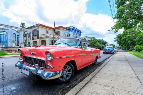 Havana Cuba Pink vintage classic american car in a typical colorful street with sunny blue sky 