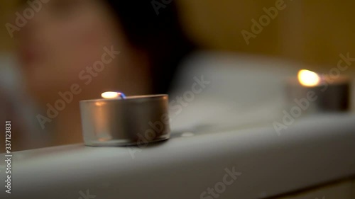 Girl relaxing in bath with canldles, romantic atmosphere, rest at home photo