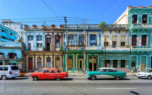 Havana Cuba Typical collection of old vintage colored houses in downton with american classic cars. © Brice