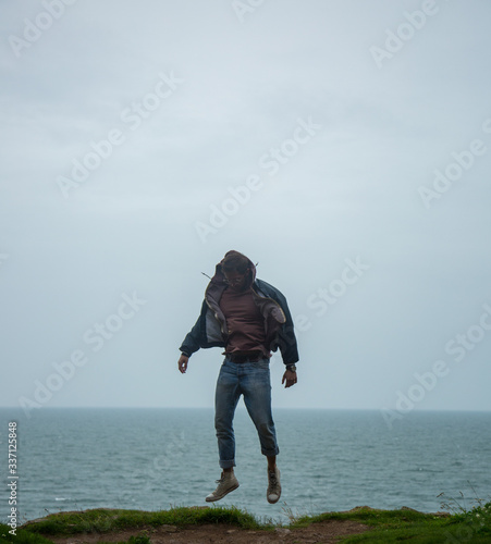 Vászonkép Model levitating near ocean