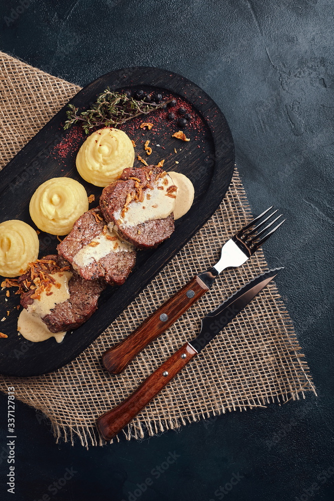 Delicious tender pork chop with mashed potatoes, traditional Italian cuisine. Food photo, wood background. Low key. Top view of copy space Delicious tender pork chop with mashed potatoes, traditional Italian cuisine. Food photo, wood background. Low key. Top view of copy space