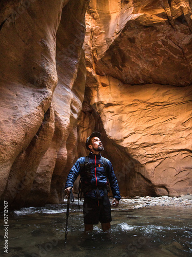 photographer in the river in Narrows, Zion UT