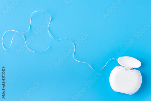 Dental floss on a blue background. Free space for text