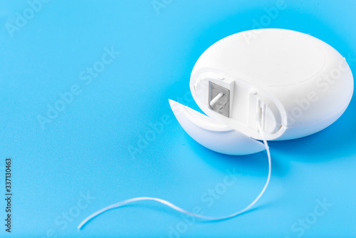 Dental floss on a blue background. Free space for text