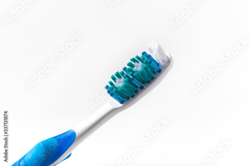 Blue toothbrush on a white background close up